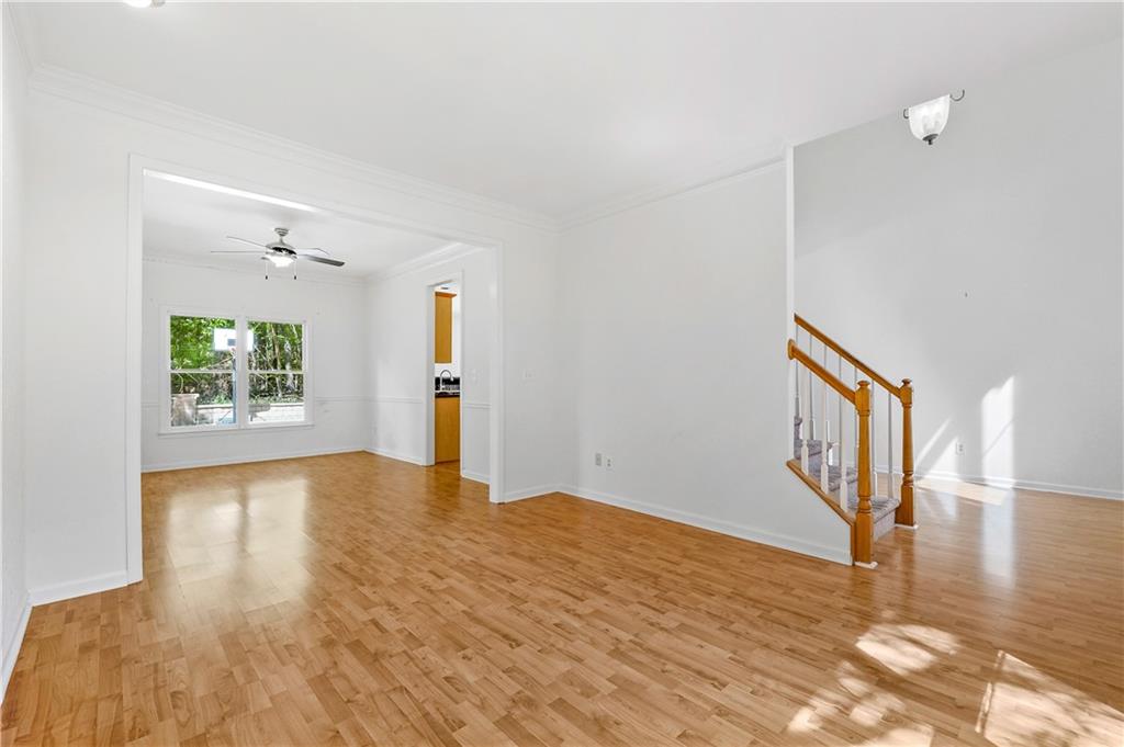873 Red Rock Court Suwanee, GA 30024 - Photo 10 of 36 a view of an empty room with wooden floor and a window
