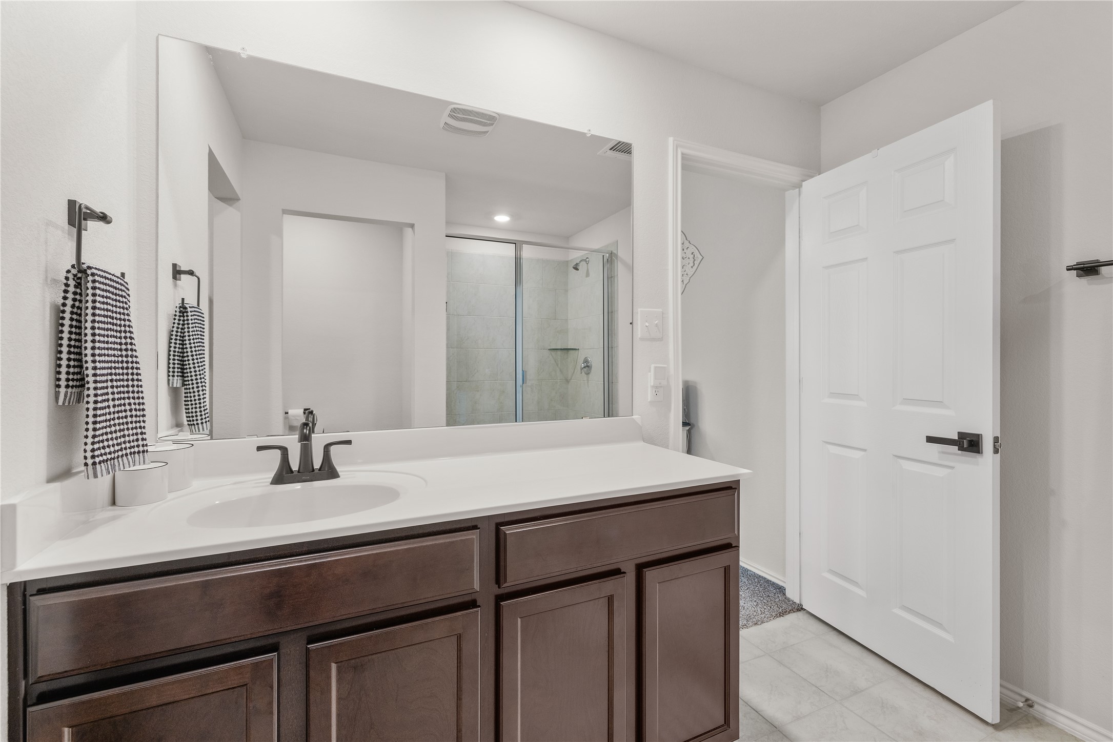 583 Taggart Trail Jarrell, TX 76537 - Photo 13 of 21 Full bathroom with a stall shower, vanity, and light tile patterned floors