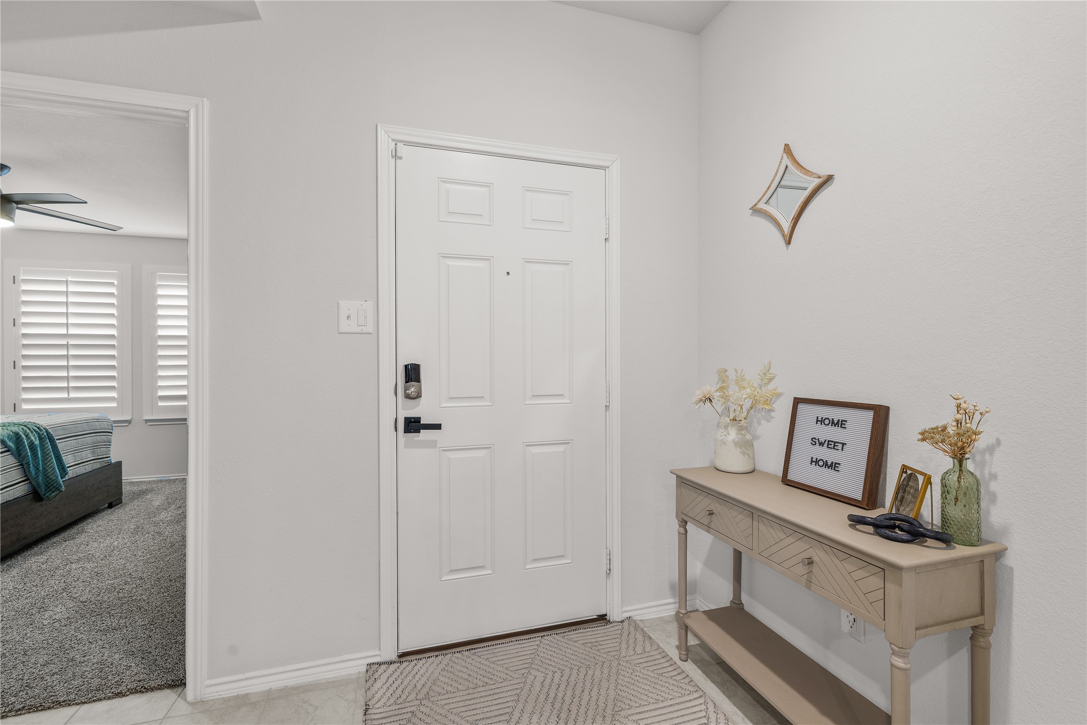 583 Taggart Trail Jarrell, TX 76537 - Photo 5 of 21 Foyer with a ceiling fan and light carpet