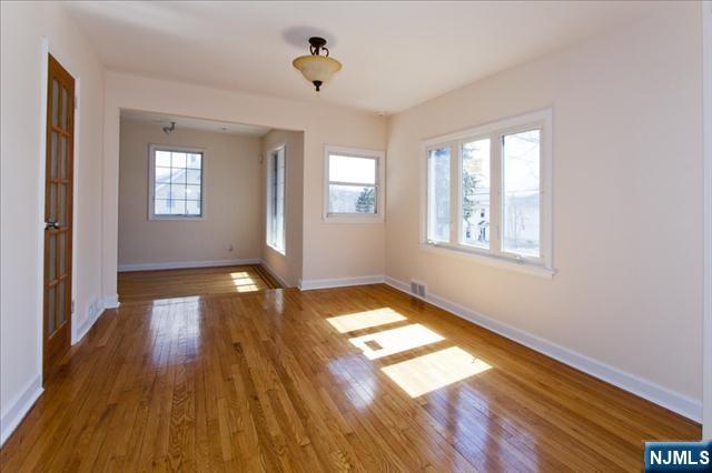 177 Magnolia Avenue Cresskill, NJ 07626 - Photo 2 of 15 a view of empty room with wooden floor and fan