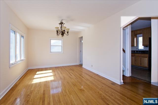 177 Magnolia Avenue Cresskill, NJ 07626 - Photo 3 of 15 an empty room with wooden floor and windows