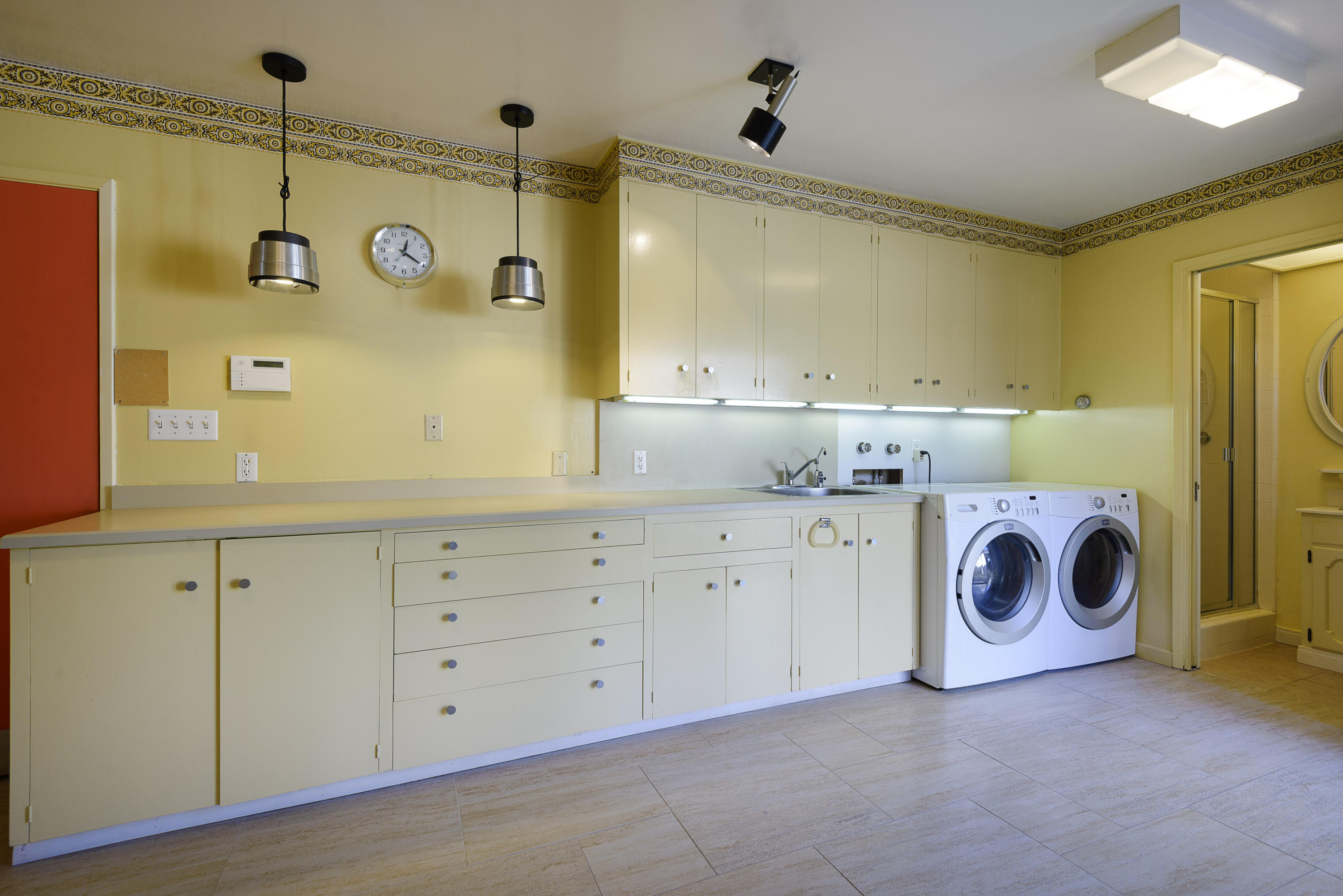 4460 Via Alegre Santa Barbara, CA 93110 - Photo 13 of 18 a utility room with cabinets washer and dryer