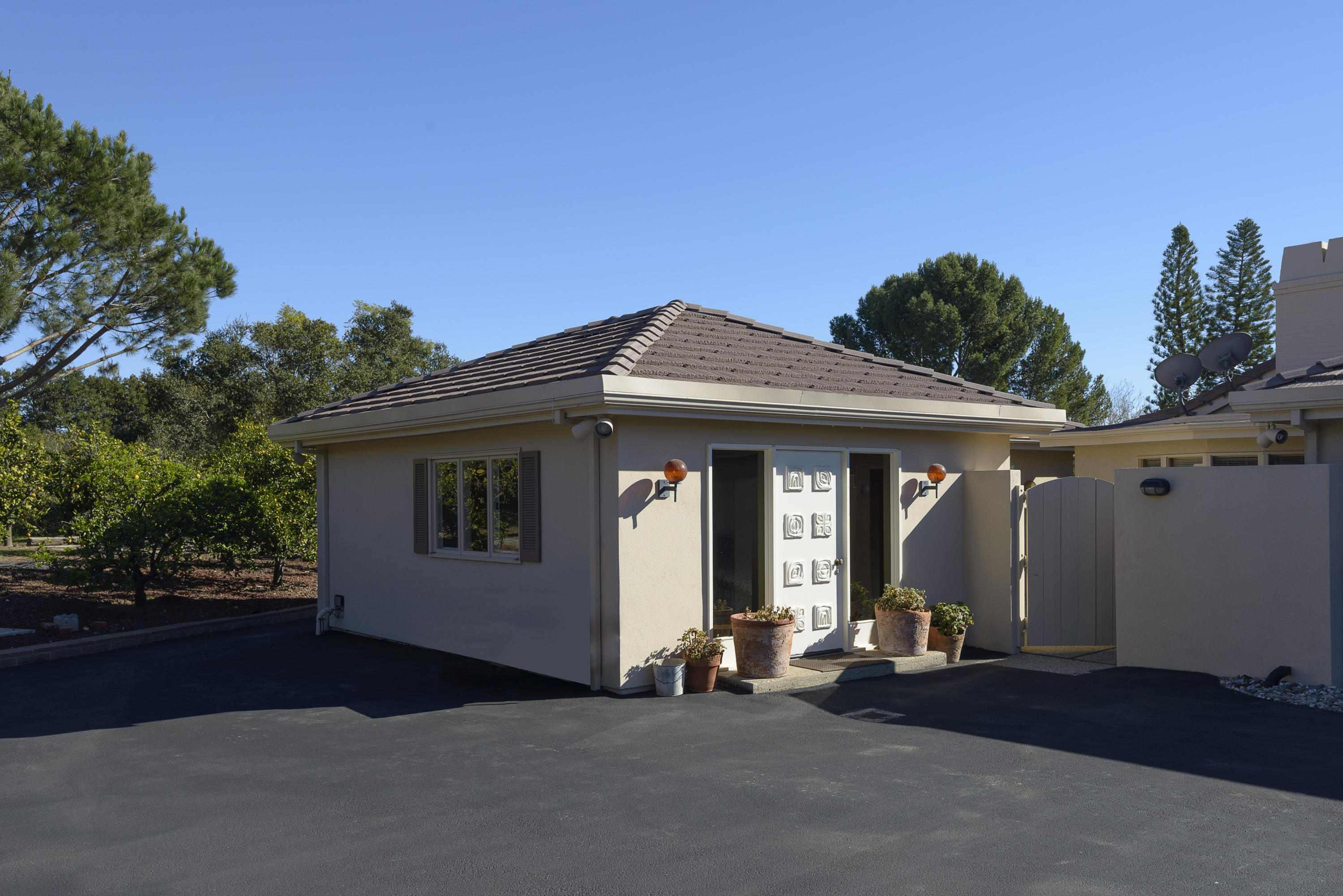 4460 Via Alegre Santa Barbara, CA 93110 - Photo 17 of 18 a view of a house with a yard and garage