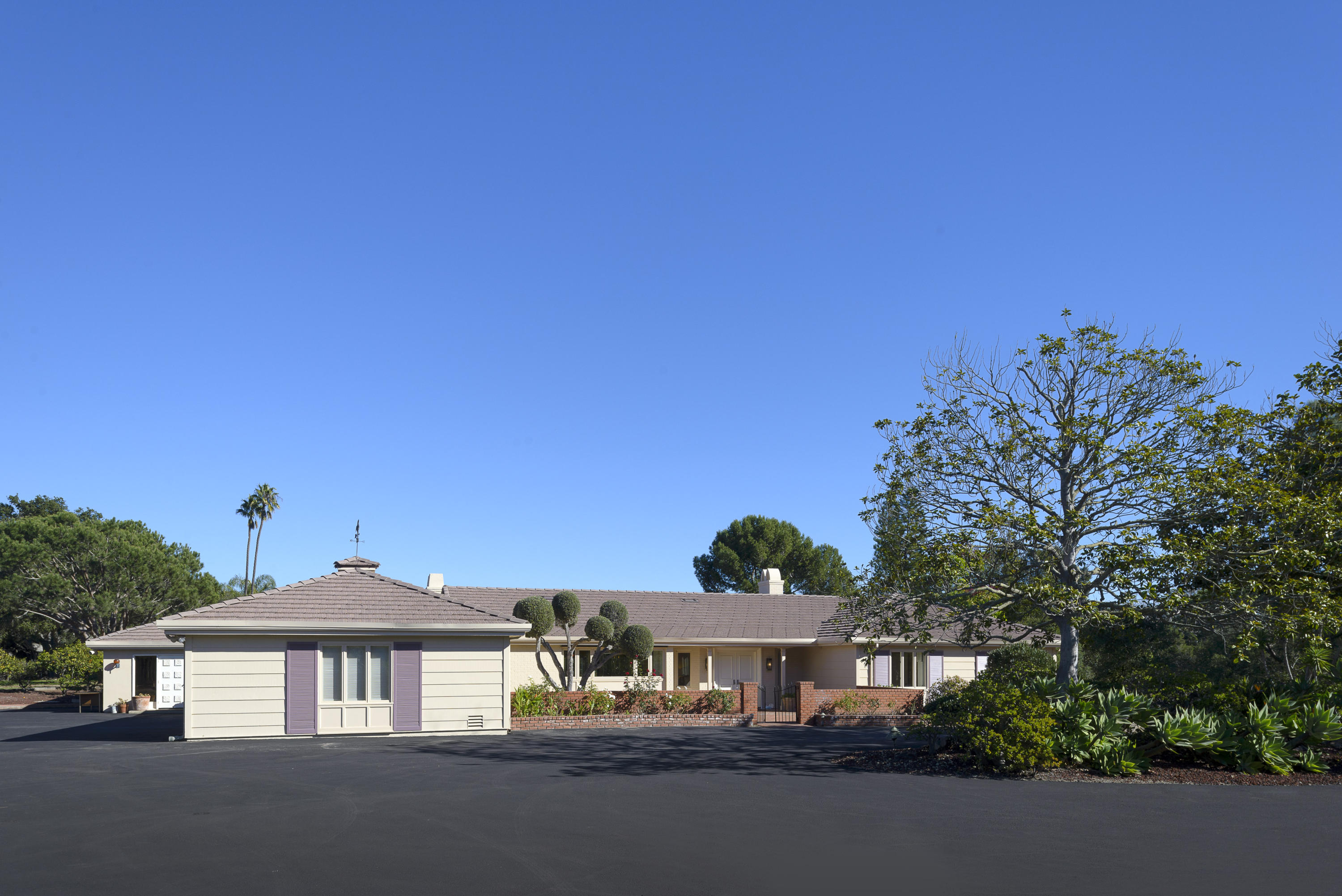4460 Via Alegre Santa Barbara, CA 93110 - Photo 3 of 18 a front view of a house with a yard and garage