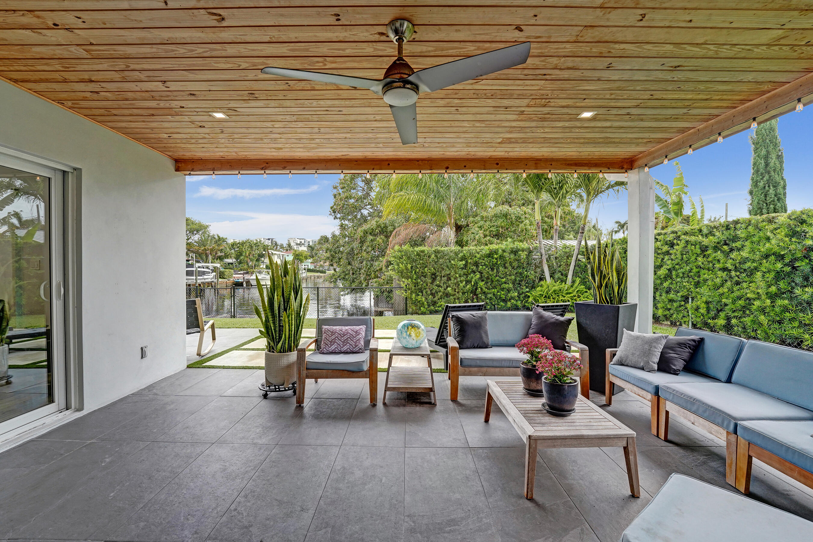 381 Southeast 3rd Street Pompano Beach, FL 33060 - Photo 18 of 41 a outdoor space with patio the couches and a dining table with garden view