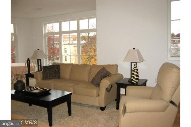 a living room with furniture and a lamp