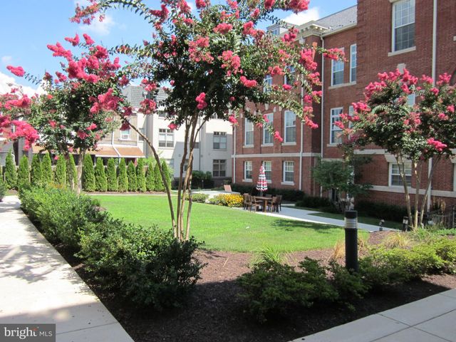 a front view of a house with a yard and fountain