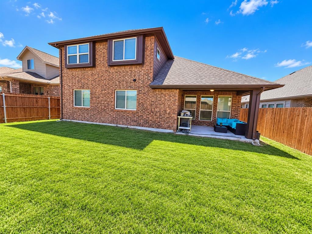 3301 Heathrow Road Mesquite, TX 75181 - Photo 25 of 26 Brick exterior with brown trim, covered patio, and fenced yard
