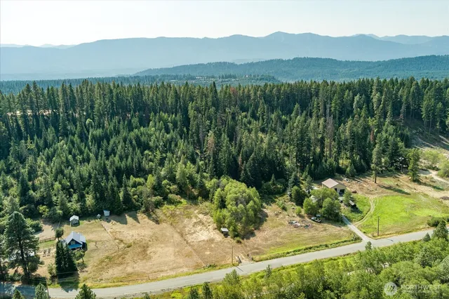 a view of a mountain with a yard