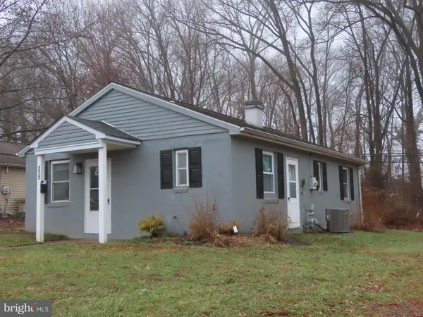 a house that has a tree in front of the house