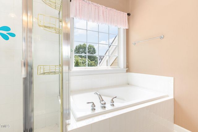 a bathroom with a bathtub and a window