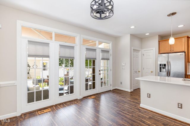 a view of a big room with wooden floor and windows