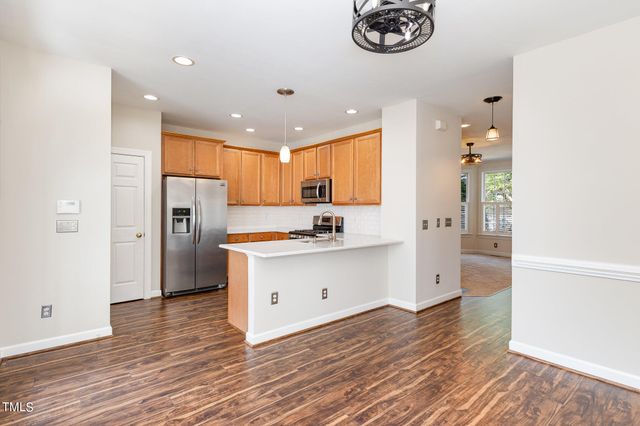 a kitchen with stainless steel appliances a refrigerator and a stove