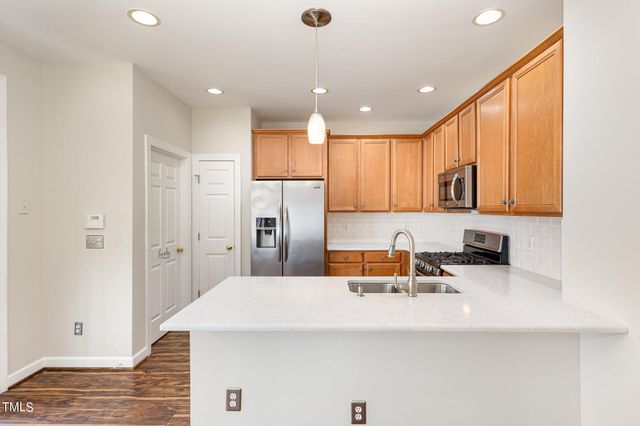 a kitchen with stainless steel appliances a refrigerator and a sink