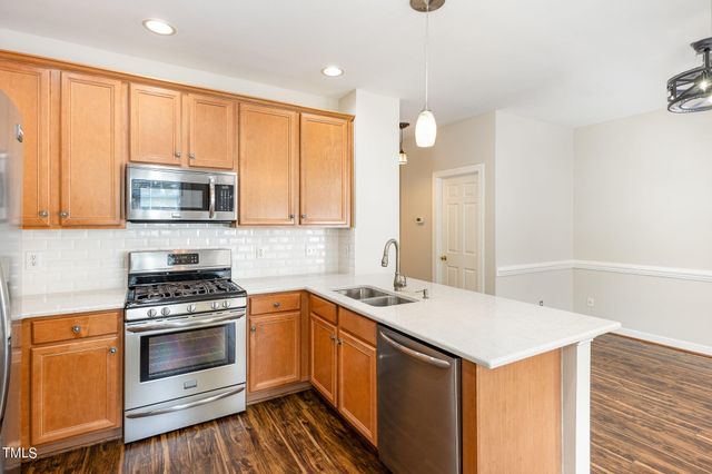 a kitchen with a sink stove and microwave