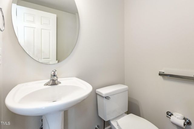 a bathroom with a sink a mirror and a toilet