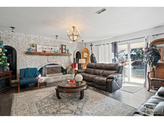 a living room with furniture potted plant and a fireplace