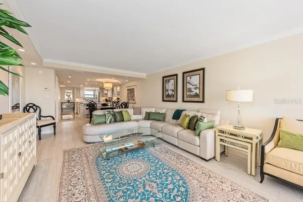 a living room with furniture a rug and a lamp