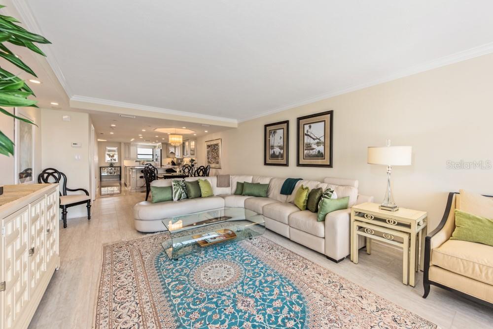 5770 Midnight Pass Road, Unit 605 Sarasota, FL 34242 - Photo 13 of 42 a living room with furniture a rug and a lamp
