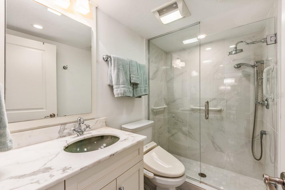 5770 Midnight Pass Road, Unit 605 Sarasota, FL 34242 - Photo 19 of 42 a bathroom with a sink a toilet and shower