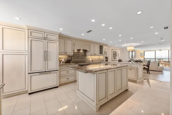 a kitchen with stainless steel appliances granite countertop refrigerator sink and cabinets