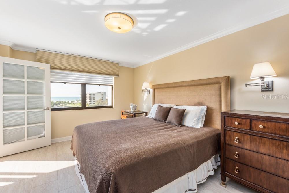 5770 Midnight Pass Road, Unit 605 Sarasota, FL 34242 - Photo 21 of 42 a bedroom with a bed and a window