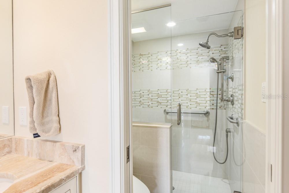 5770 Midnight Pass Road, Unit 605 Sarasota, FL 34242 - Photo 24 of 42 a bathroom with a shower