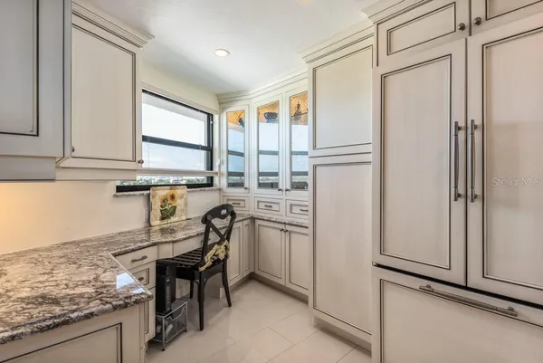 a kitchen with stainless steel appliances granite countertop a refrigerator and a stove