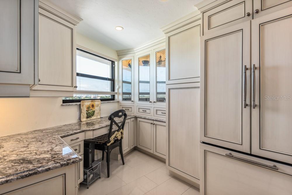 5770 Midnight Pass Road, Unit 605 Sarasota, FL 34242 - Photo 3 of 42 a kitchen with stainless steel appliances granite countertop a refrigerator and a stove
