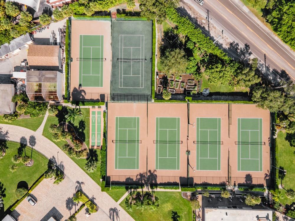 5770 Midnight Pass Road, Unit 605 Sarasota, FL 34242 - Photo 33 of 42 a front view of a building with a garden and plants