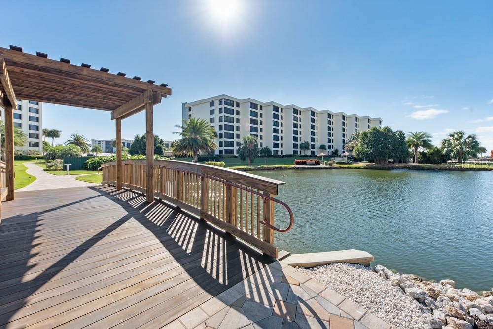 5770 Midnight Pass Road, Unit 605 Sarasota, FL 34242 - Photo 36 of 42 a view of balcony with couch and wooden floor