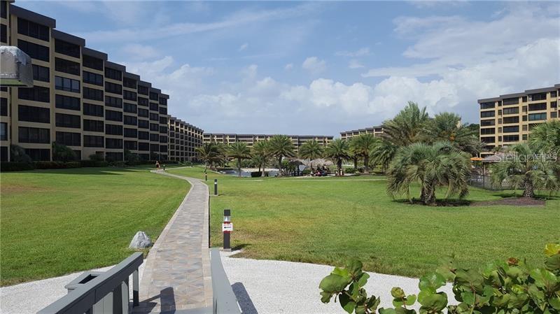 5770 Midnight Pass Road, Unit 605 Sarasota, FL 34242 - Photo 42 of 42 a view of a garden and basketball court