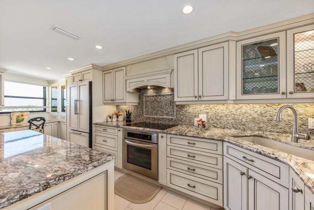 5770 Midnight Pass Road, Unit 605 Sarasota, FL 34242 - Photo 6 of 42 a kitchen with stainless steel appliances granite countertop a sink stove and refrigerator