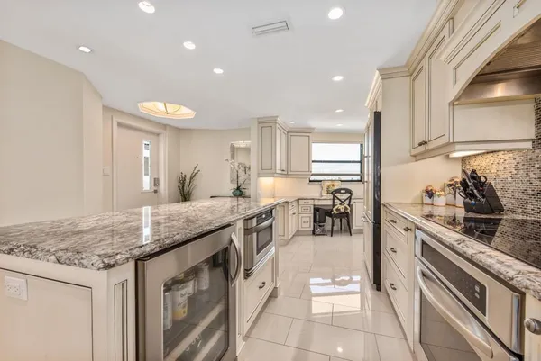 a kitchen with stainless steel appliances granite countertop a stove and a sink