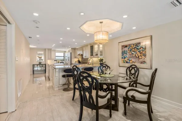a view of a dining room and livingroom with furniture and a chandelier
