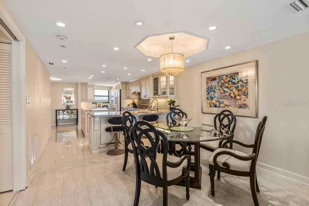 5770 Midnight Pass Road, Unit 605 Sarasota, FL 34242 - Photo 10 of 42 a view of a dining room and livingroom with furniture and a chandelier