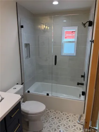 a bath room with a toilet and a bath tub