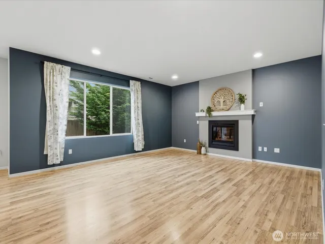 a view of empty room with a fireplace