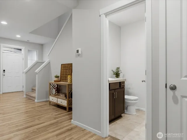 a bedroom with a bed chair and a large window
