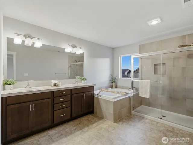 a spacious bathroom with a double vanity sink and a mirror