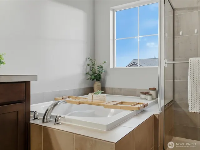 a bathroom with a tub and shower