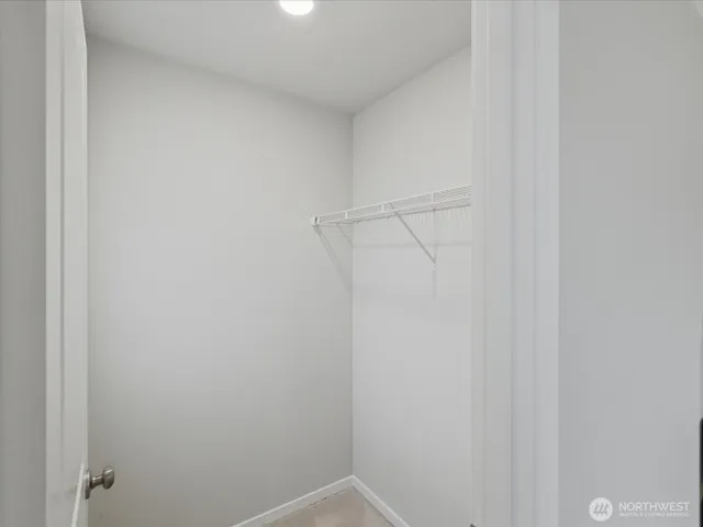 a view of storage and utility room with a hallway