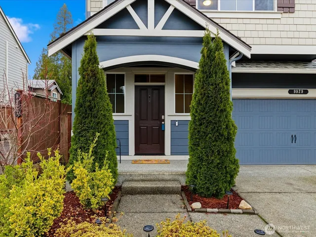 a front view of a house with a garden