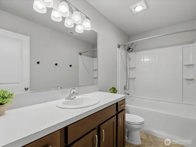 a bathroom with a sink a light fixture and a mirror