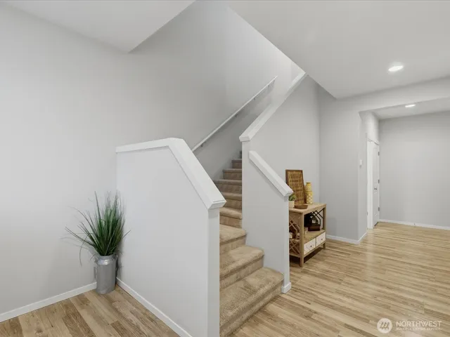 a view of entryway and hall with wooden floor