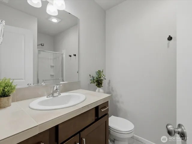 a bathroom with a sink toilet and a mirror