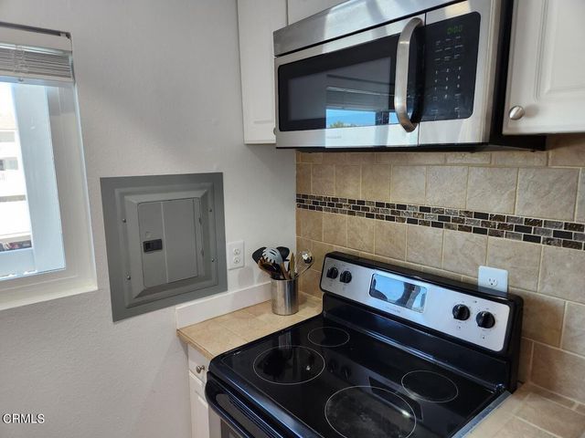a kitchen with a stove and a microwave