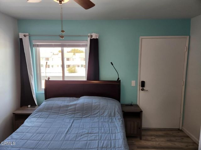 a bedroom with window and bed