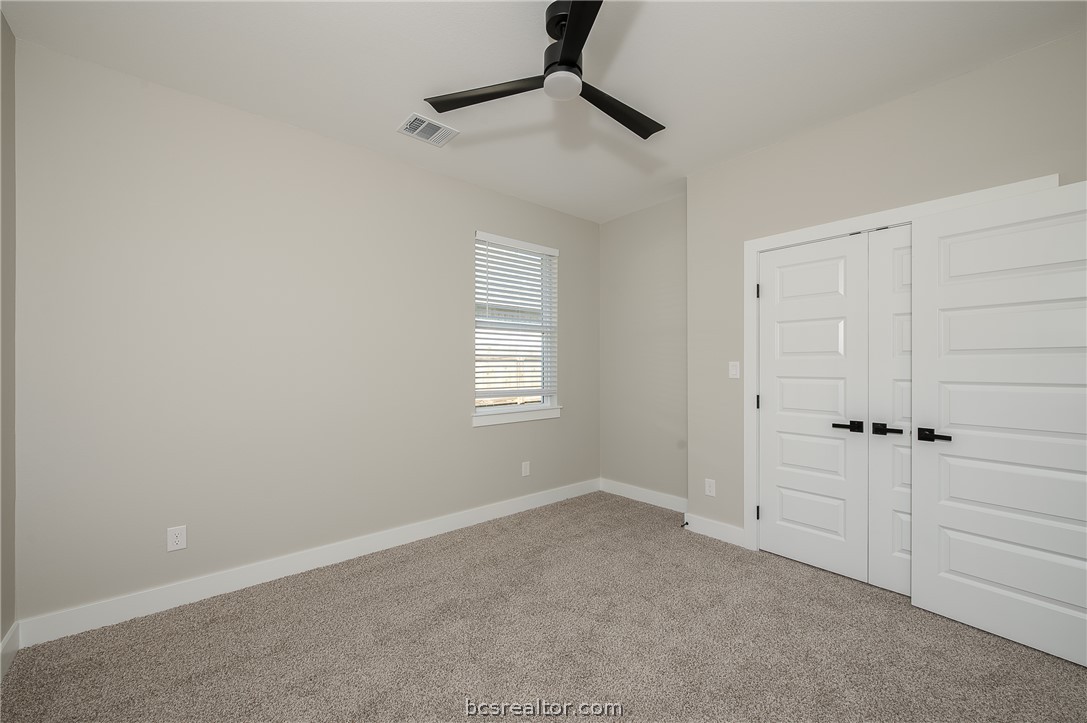 2908 GOLDBERG Drive Bryan, TX 77808 - Photo 14 of 44 Bedroom features: window treatments, base molding, ceiling fan with a light kit plus remote control and carpeting.