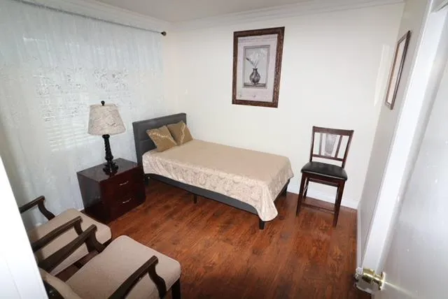 a bedroom with a bed and a mirror